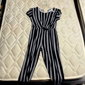 A black and white jumpsuit with a black and white tie on it